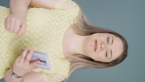 Vertical-video-of-Dancing-woman-with-phone-in-hand.